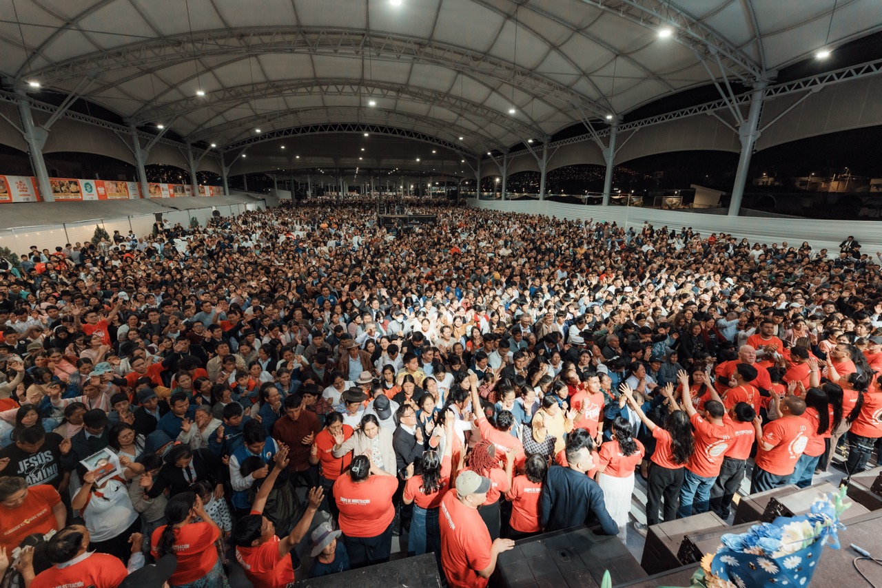 A packed Gospel Campaign crowd in Ayacucho, Peru with hands raised in worship