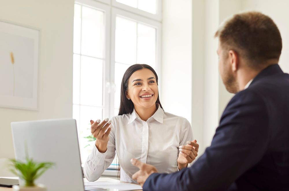 Financial advisor speaking with a small business client in an office