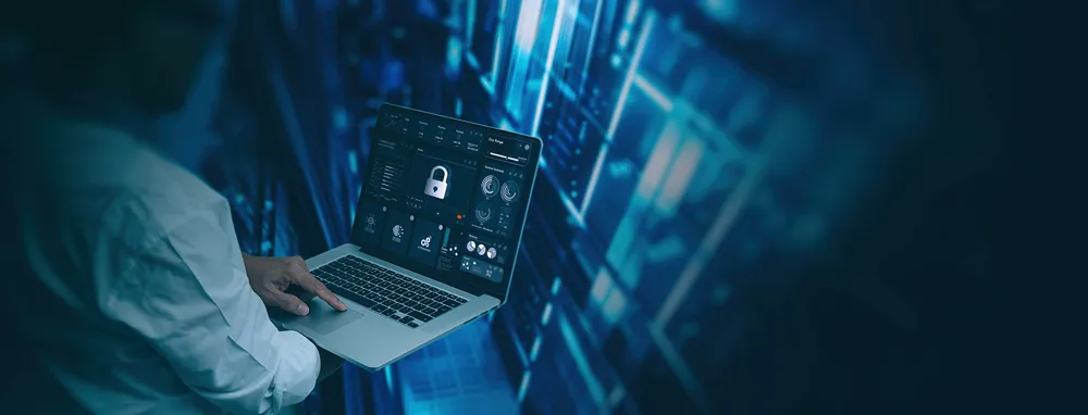 Engineer working on a laptop with a security padlock icon overlay
