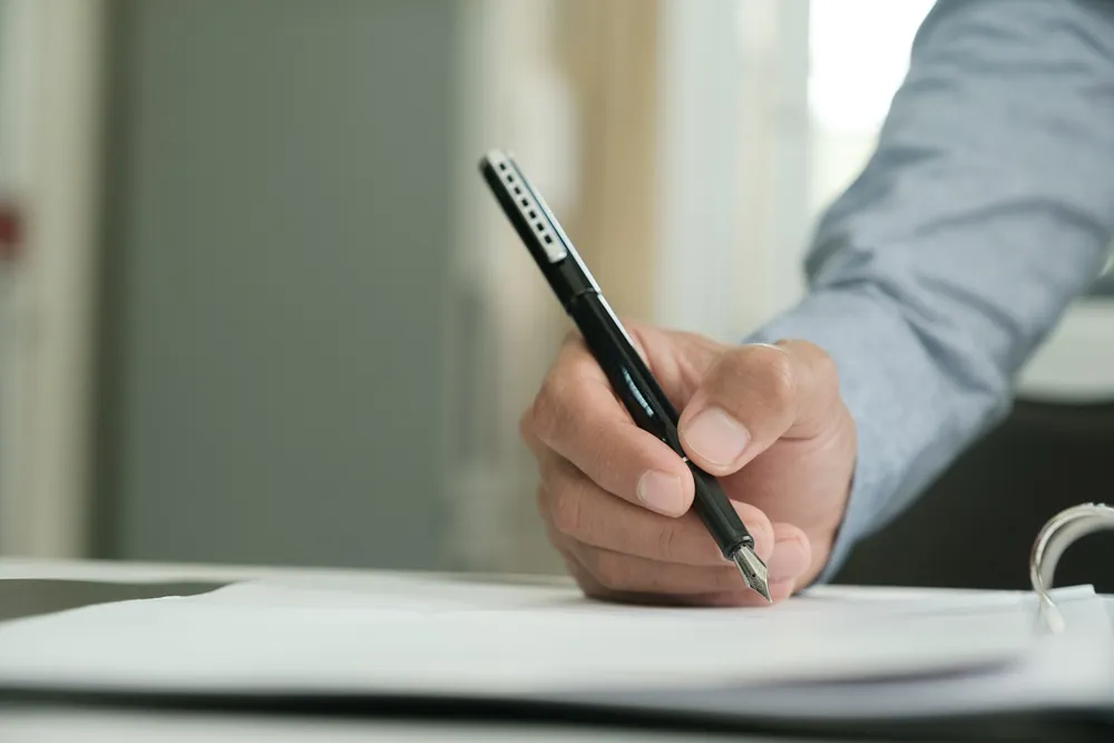 Close-up of a businessman signing a contract
