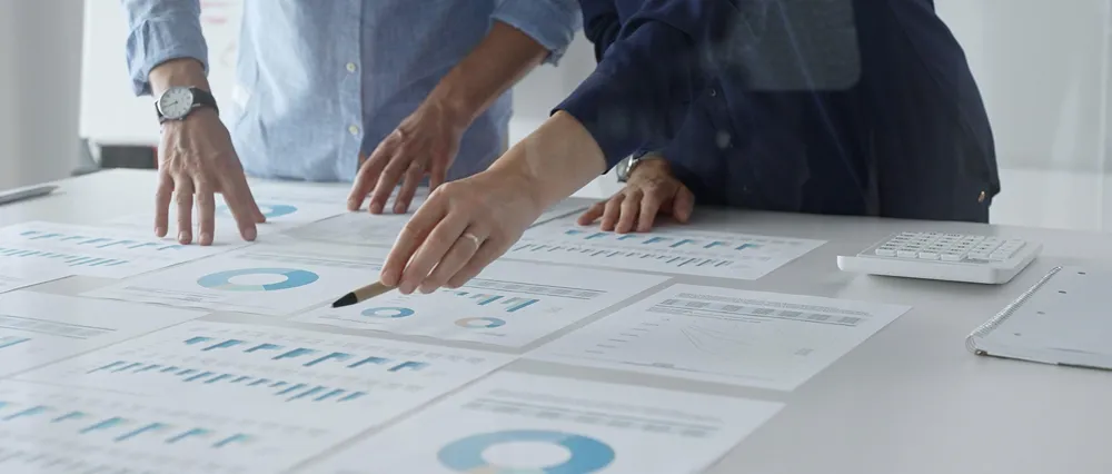 Professional team reviewing financial reports and planning strategy in a modern office.