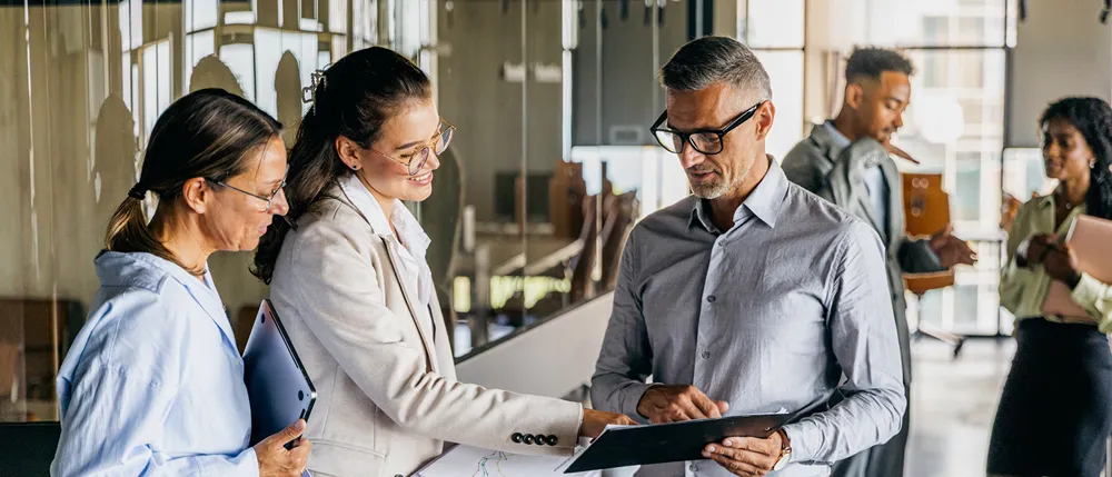 Diverse manager reviewing a contract with a colleague.