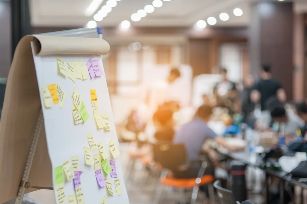 Team mapping a SLED bid pipeline with sticky notes