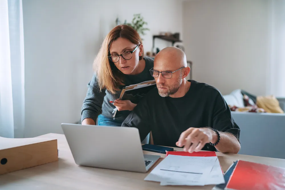 Small business owners reviewing their budget for market intelligence tools