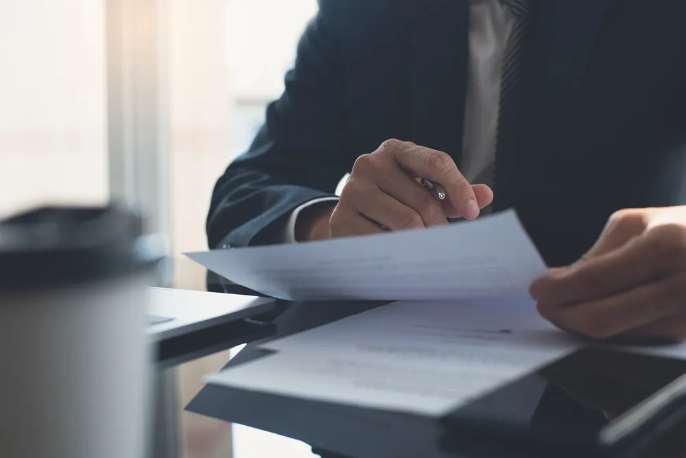Contractor reading a teaming agreement before signing it