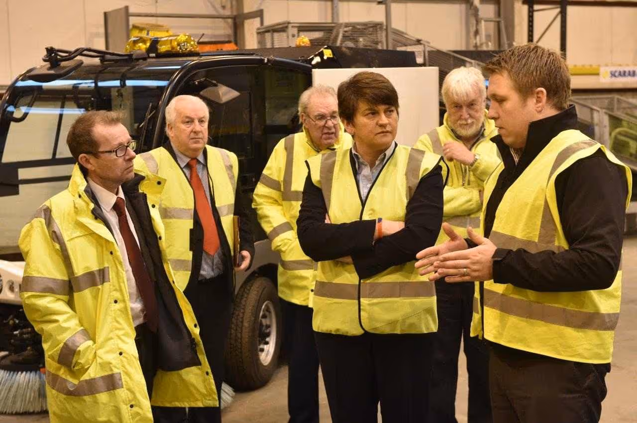 Six people all in Hi-Vis jackets infront of LCV