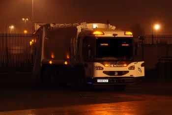 RCV parked with lights on in dark