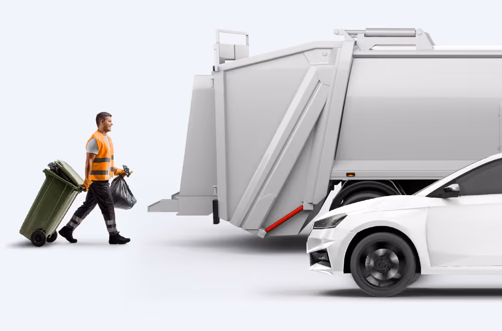 Refuse worker collecting bins.