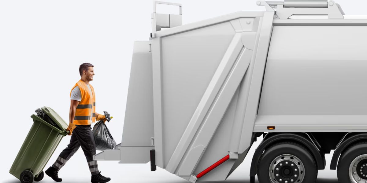 A refuse collector wearing a high-visibility orange vest pulls a green wheelie bin and carries a black rubbish bag towards the rear of a white waste collection lorry.