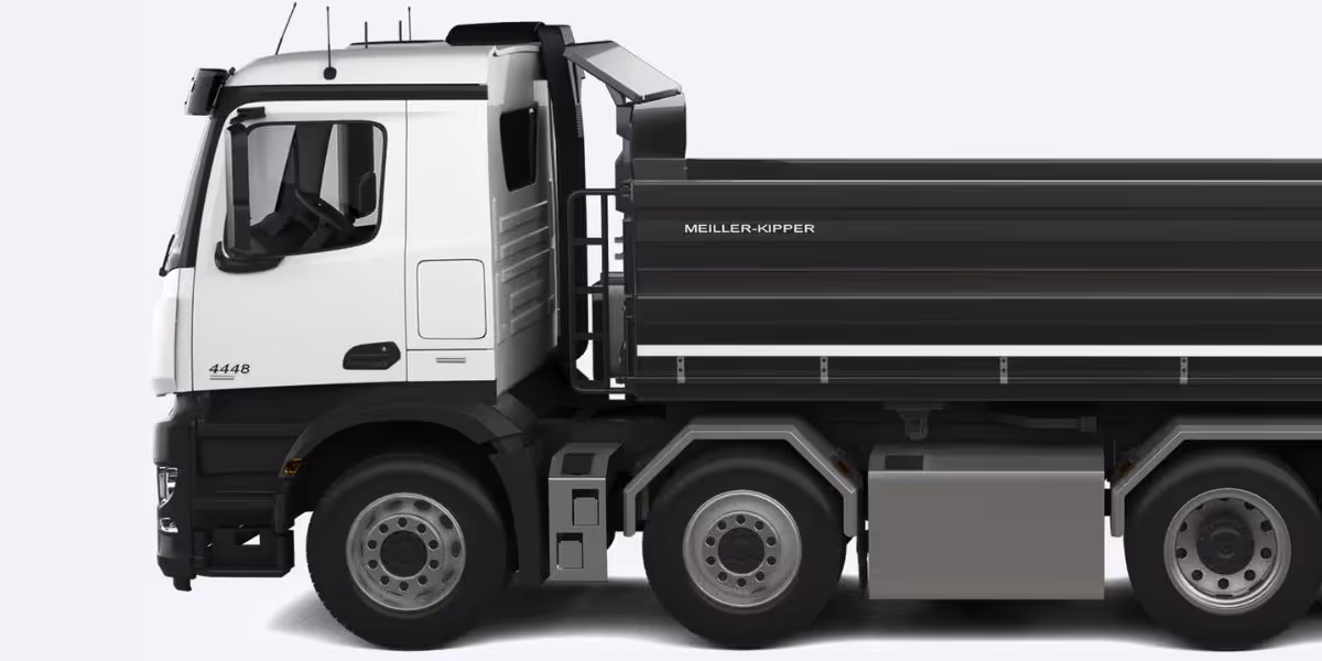 A cyclist wearing an orange jersey and black helmet is riding closely behind a large white refuse collection truck, appearing to be in a dangerous position directly behind the rear loading area.