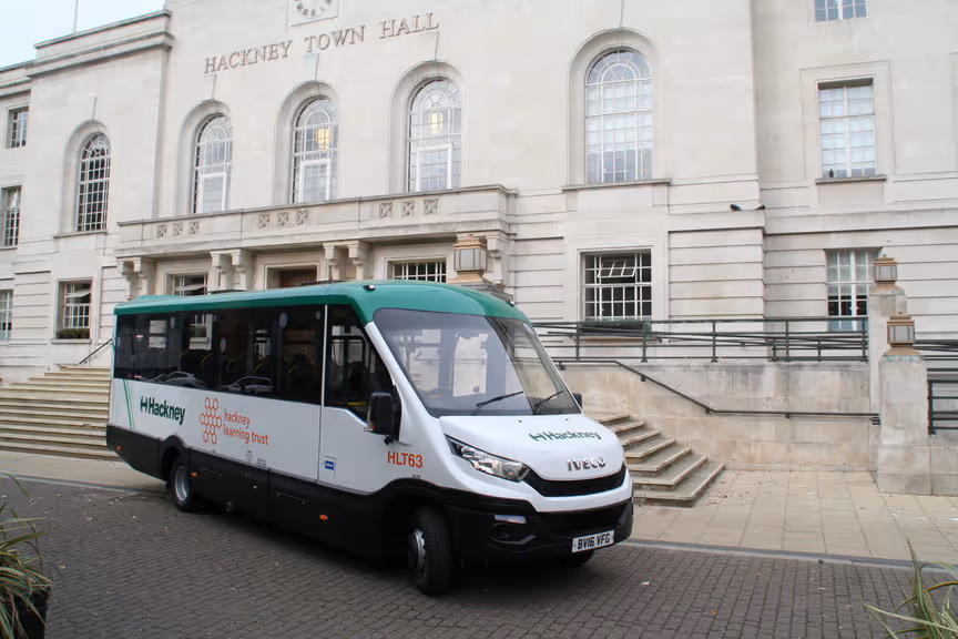 Hackney Community Transport bus parked outside Hackney Town Hall, highlighting cyclist safety equipment fitted to the vehicle.