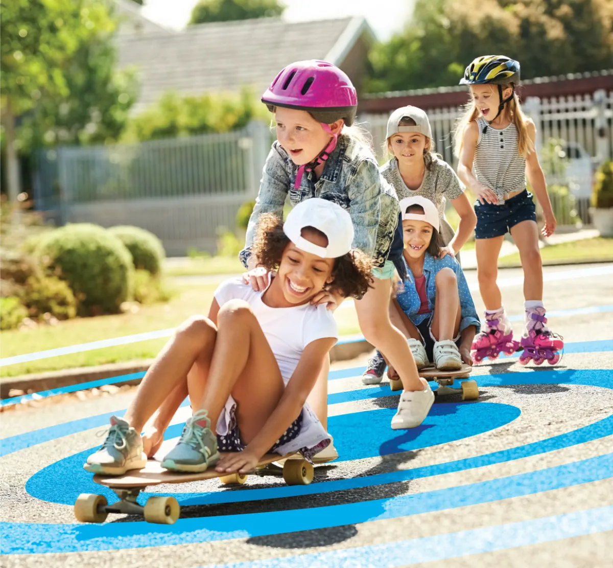 Shot of group of little boys and girls playing with skateboards outdoors