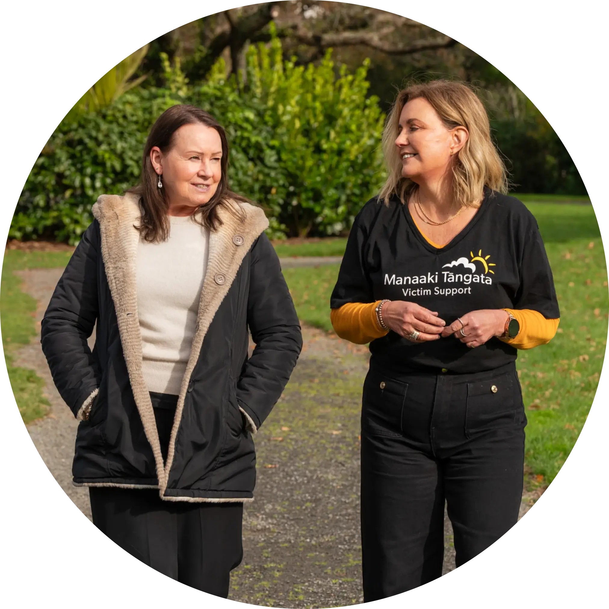 Victim support worker having a conversation with a victim in the park