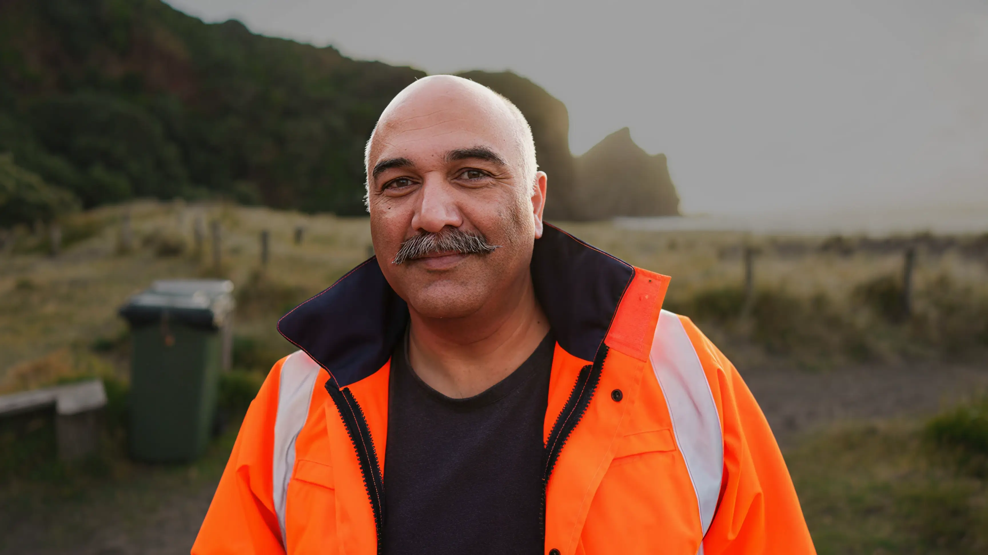 man in high-vis vest smiling