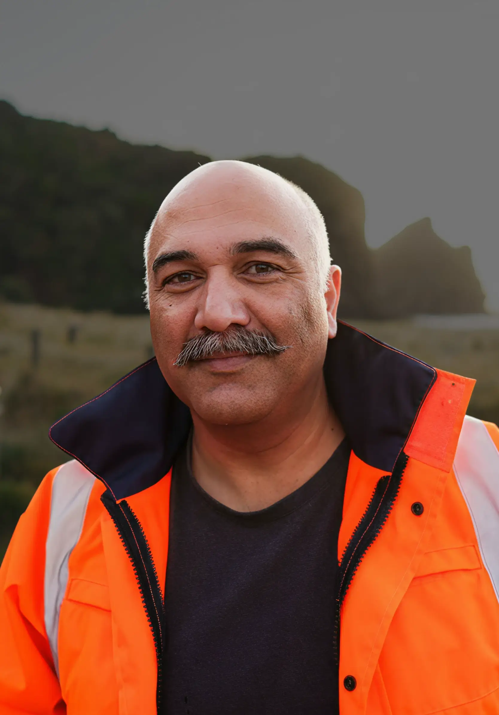 man in high-vis vest smiling