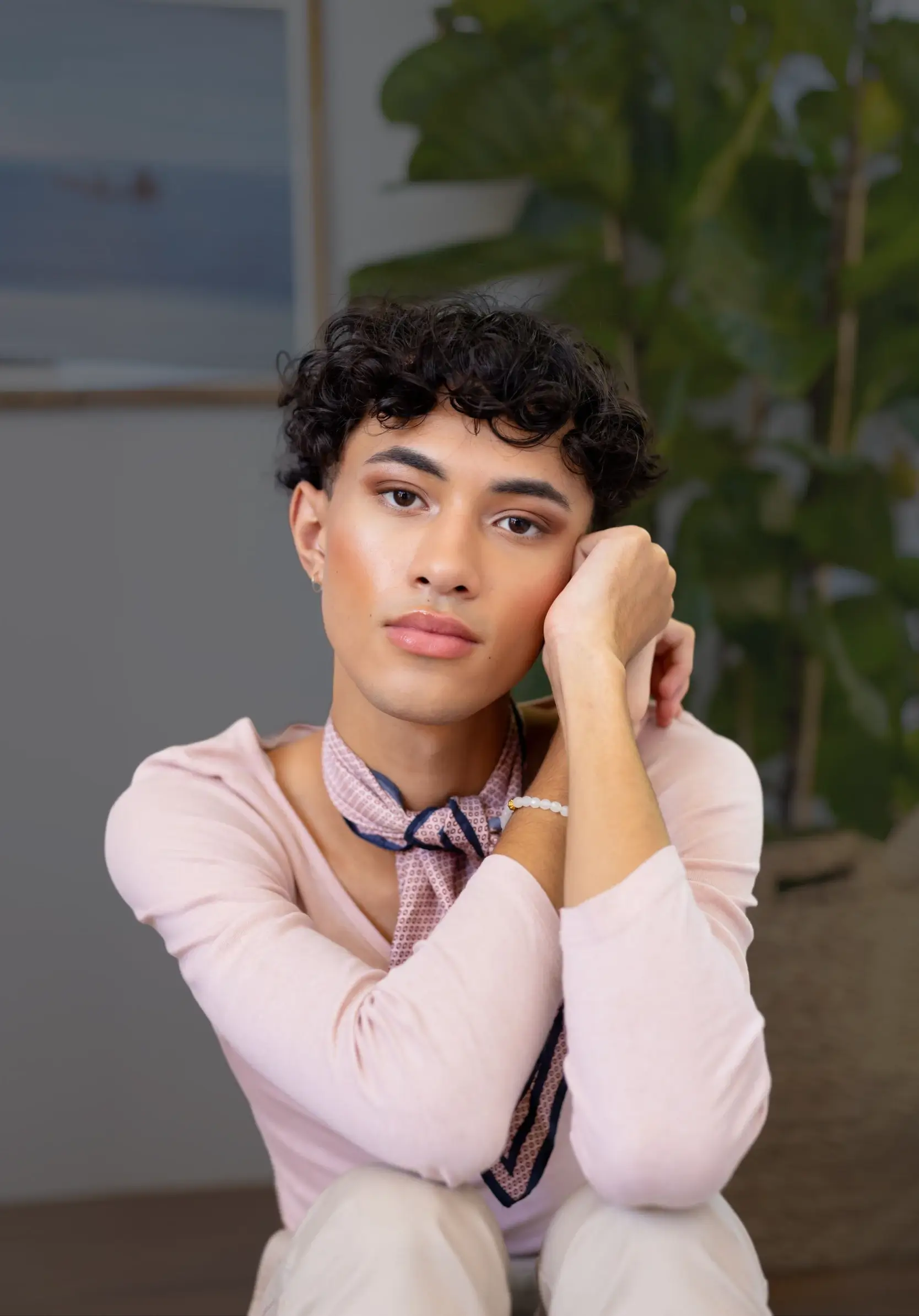 non-binary person looking thoughtful