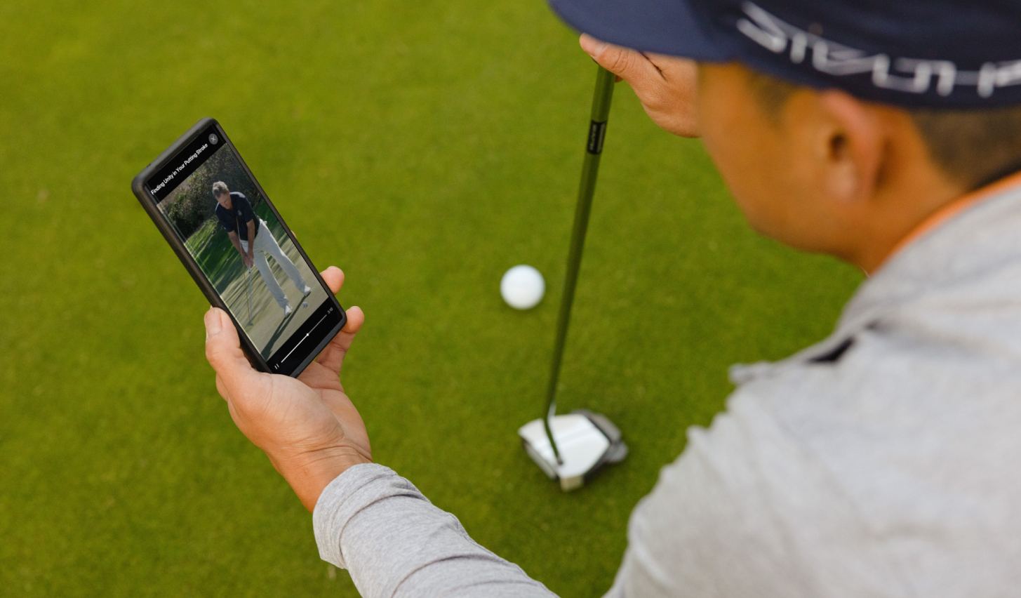 a man using a coaching example for how to putt