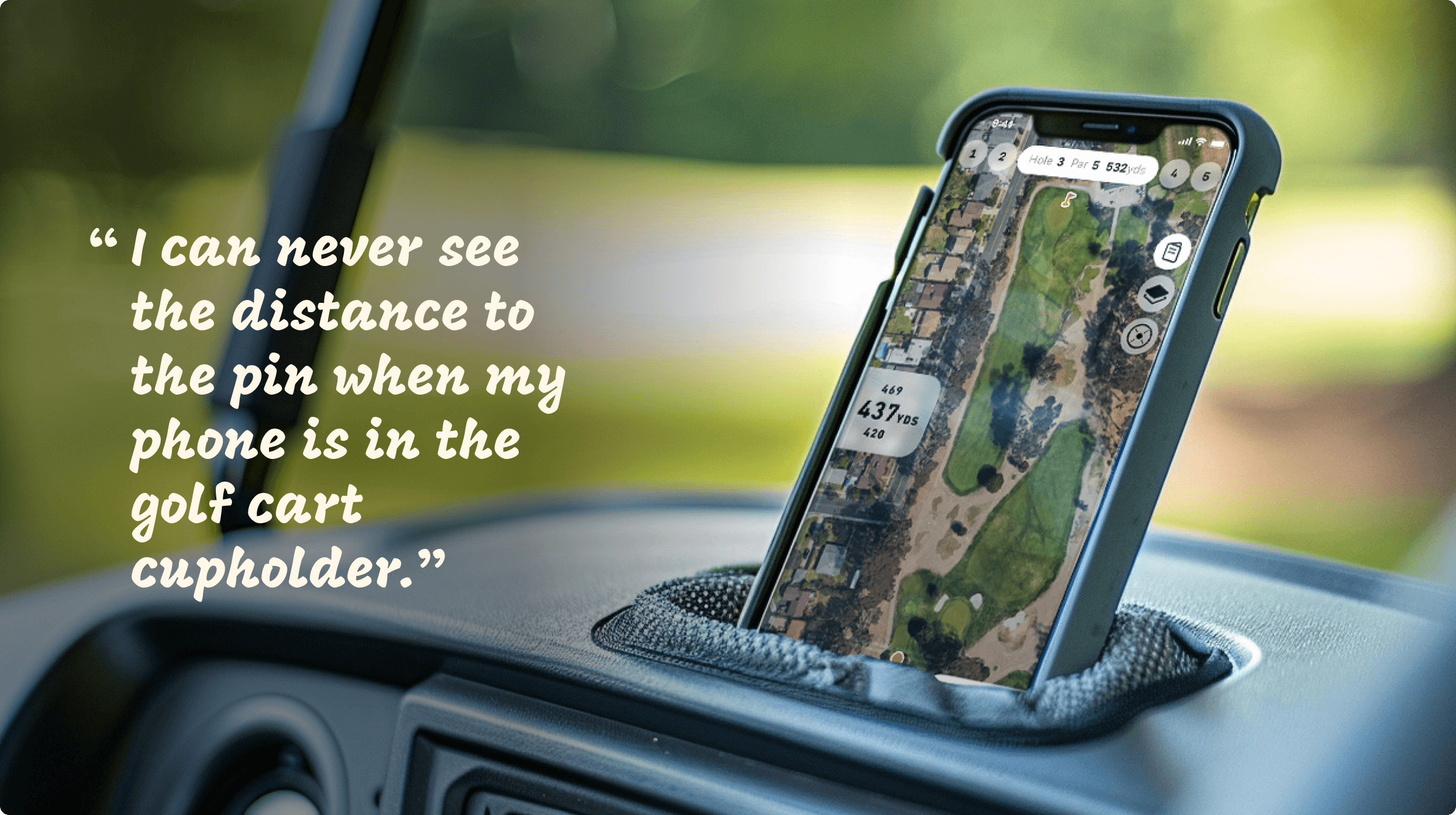 A phone in the cup holder of a golf cart showcasing round tracking software