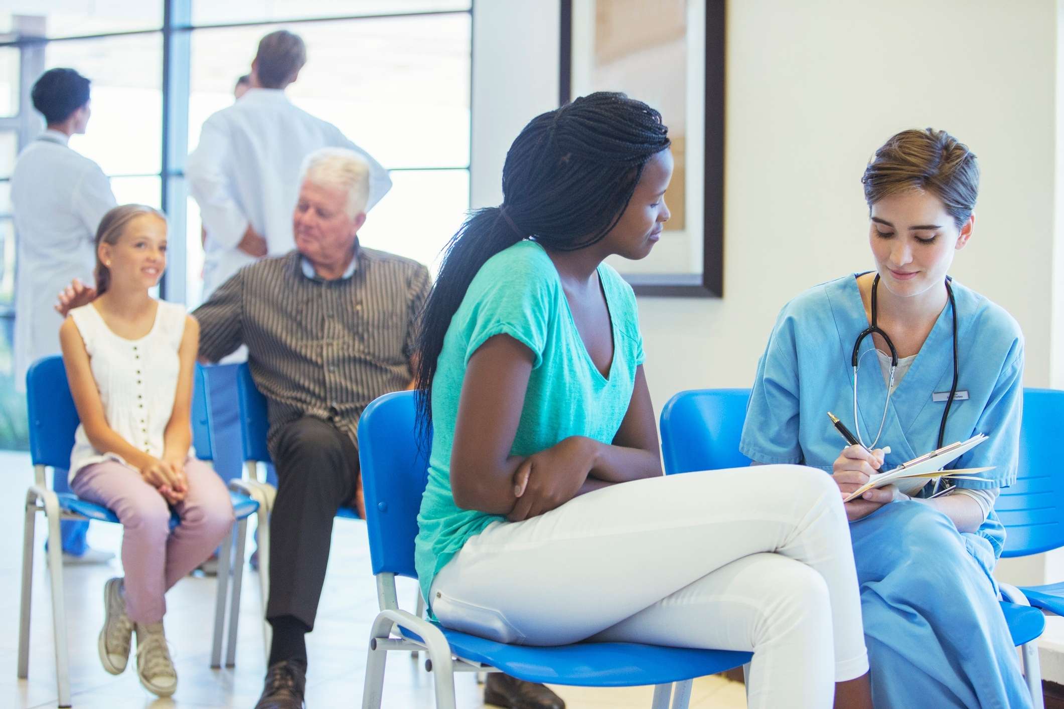 Nurse speaking with patient in hospital room, representing San Diego hospital negligence lawyer.