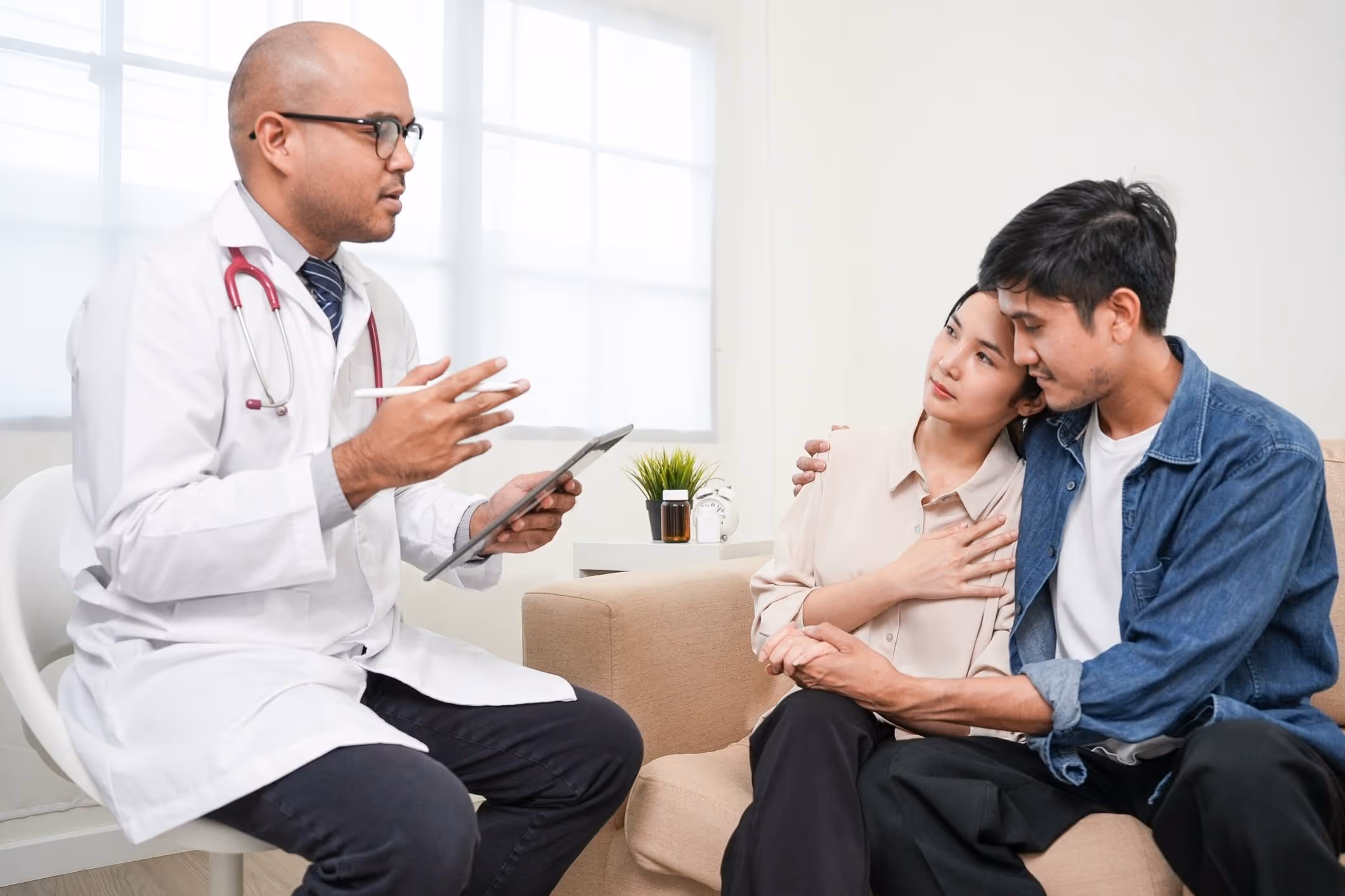 A doctor discusses test results with couple, reflecting Oceanside medical malpractice lawyer cases.