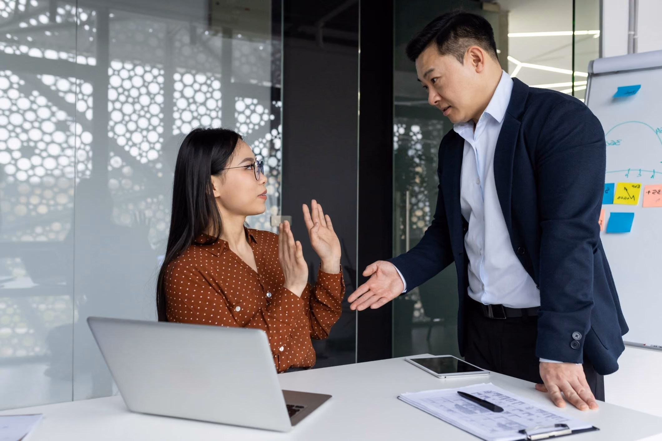 Boss touching female employee in office, representing San Diego workplace sexual harassment lawyer cases.