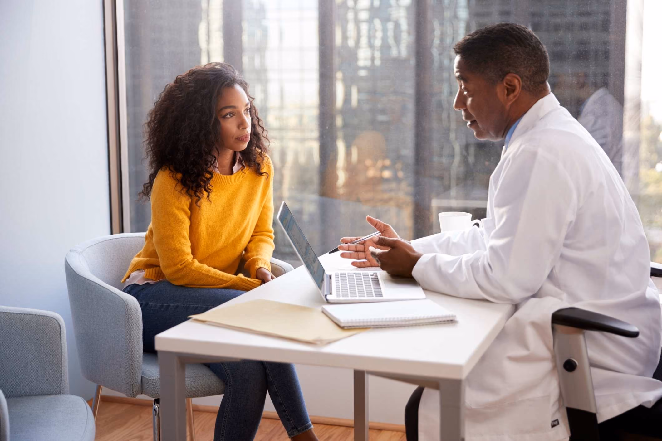 Woman speaking to doctor is advised to contact a San Marcos medical malpractice attorney.