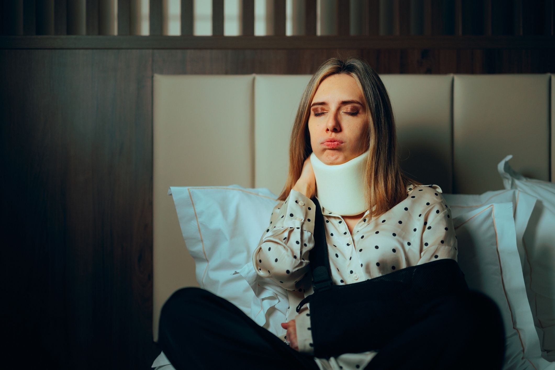 Injured woman in a neck brace and arm sling recovering with help from a Poway personal injury lawyer.