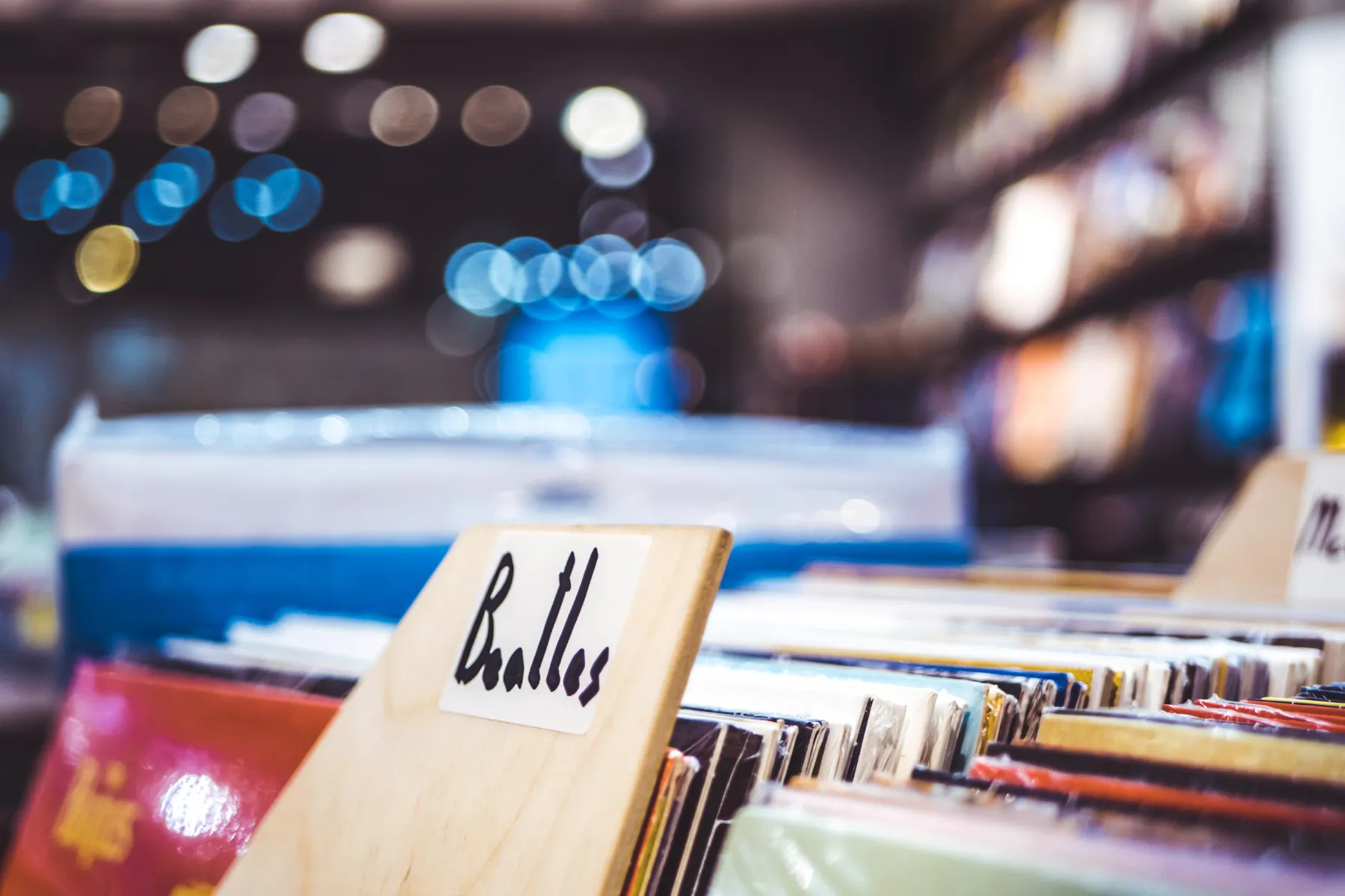 Close-up of vinyl records in a store with a wooden divider labeled 'Ballets'.