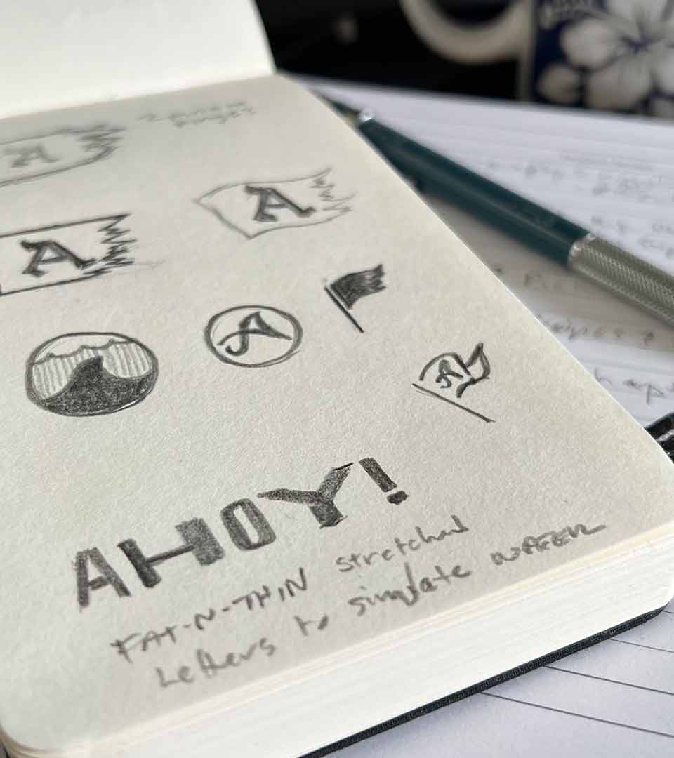 Early logo sketches in sketchbook.