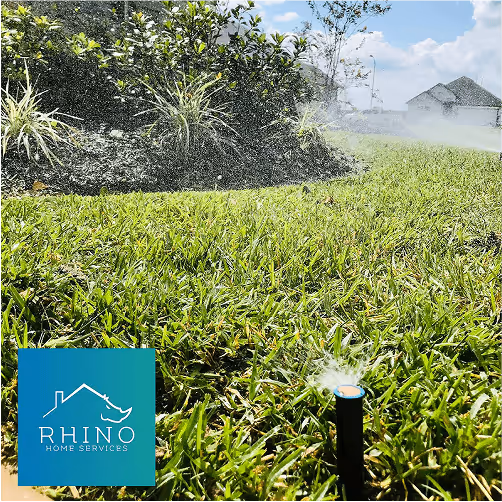 In-ground sprinkler system watering a green lawn in front of a Houston home, installed by Rhino Home Services.
