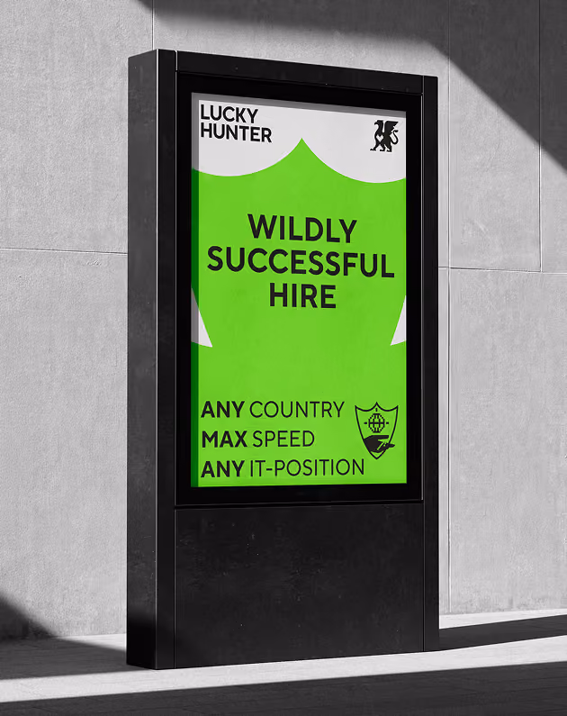 Digital billboard showing a green shield with text about successful IT hires at max speed in any country.