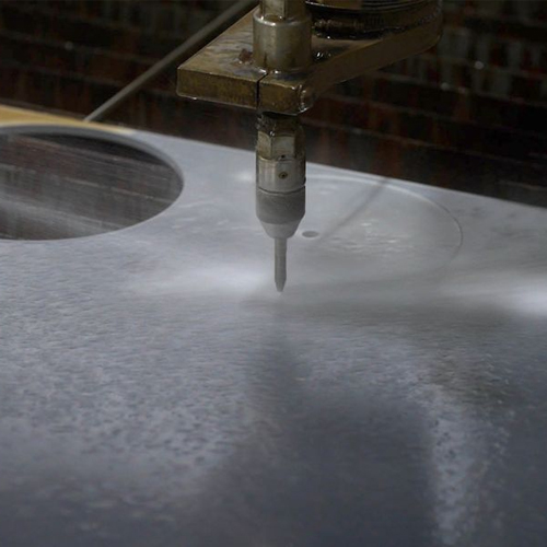 waterjet cutting a piece of steel