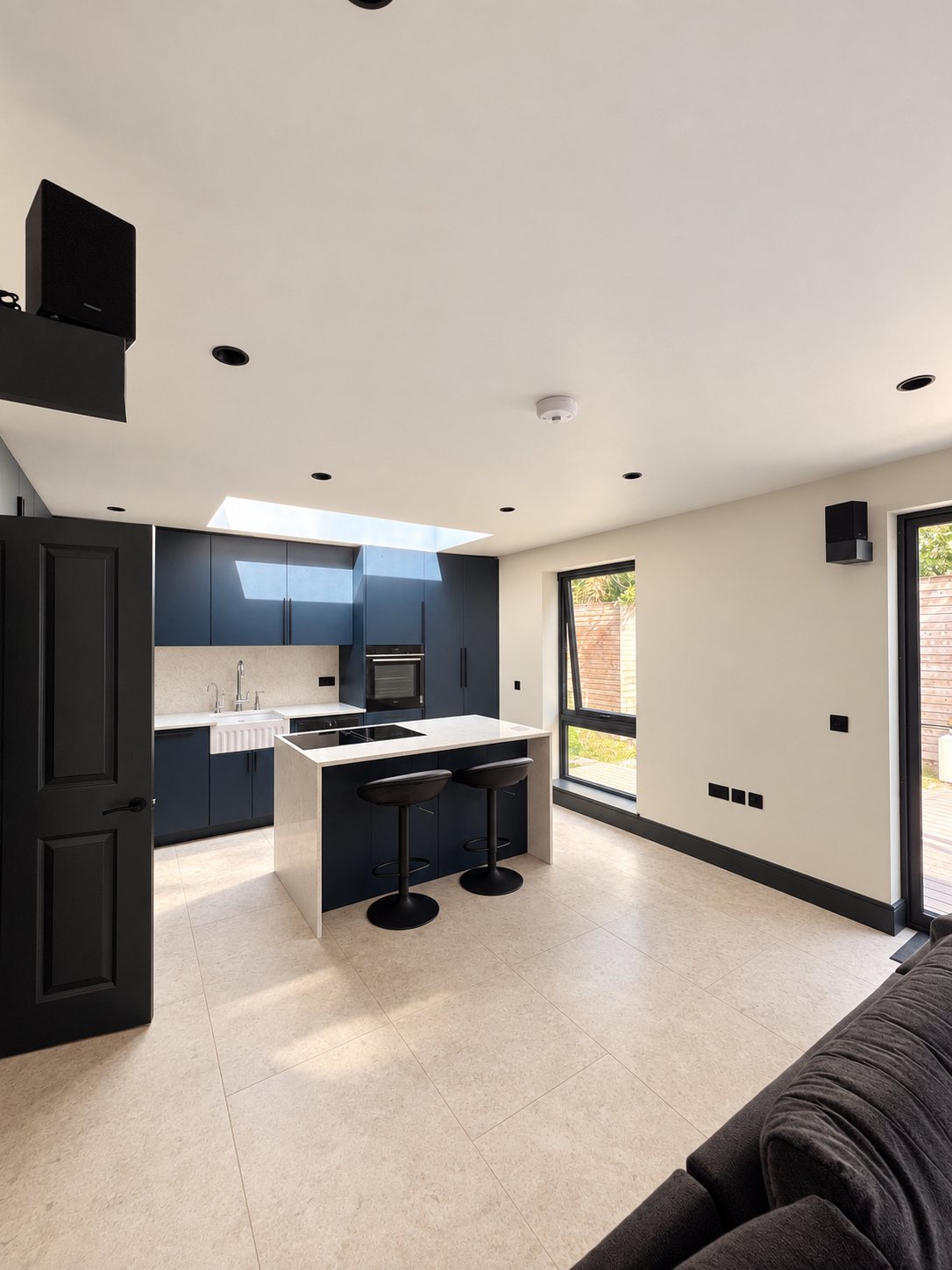 A flat in Wimbledon renovated from end to end: new open-plan kitchen with an island, living room with bifold doors, bathroom, bedrooms and hallway, all under one contract.