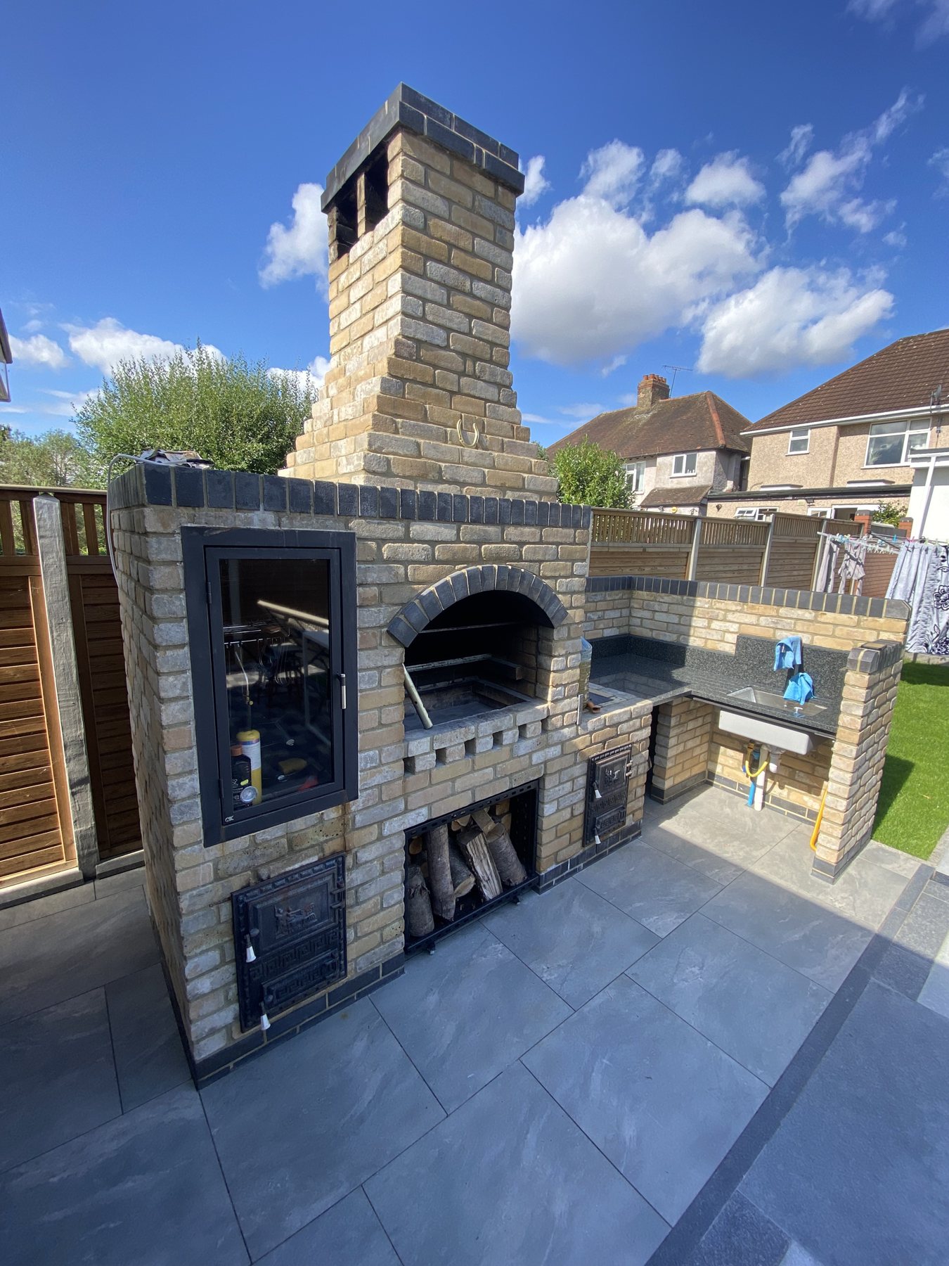 Brick outdoor kitchen with built-in barbecue