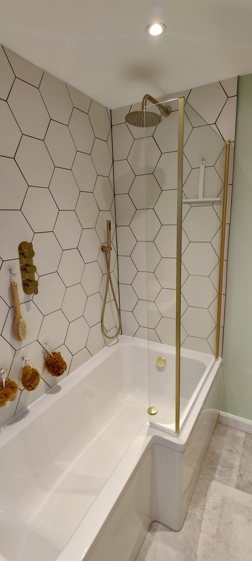 Hexagon tiles with brushed brass shower