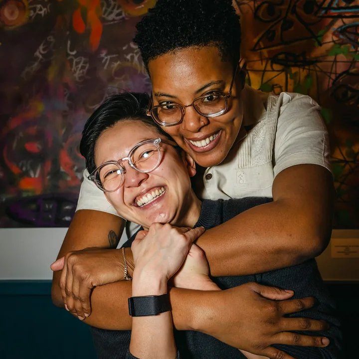 Two guests embracing at a Brooklyn Art Haus event