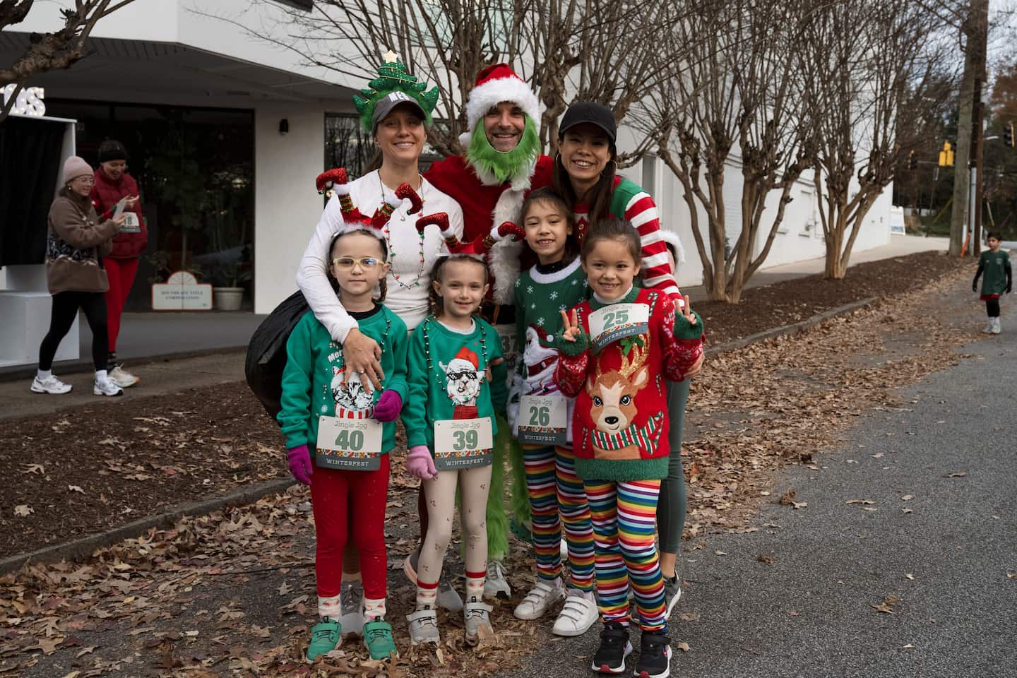 A family in festive Christmas sweaters gets ready to run the Jingle Jog.