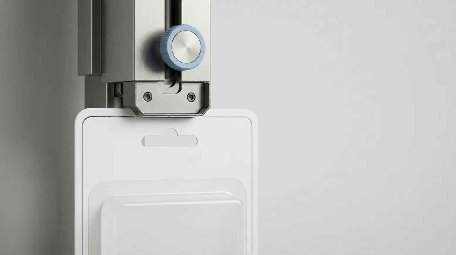 Close-up of a stainless-steel die-cutting station with a precise paperboard blister card.