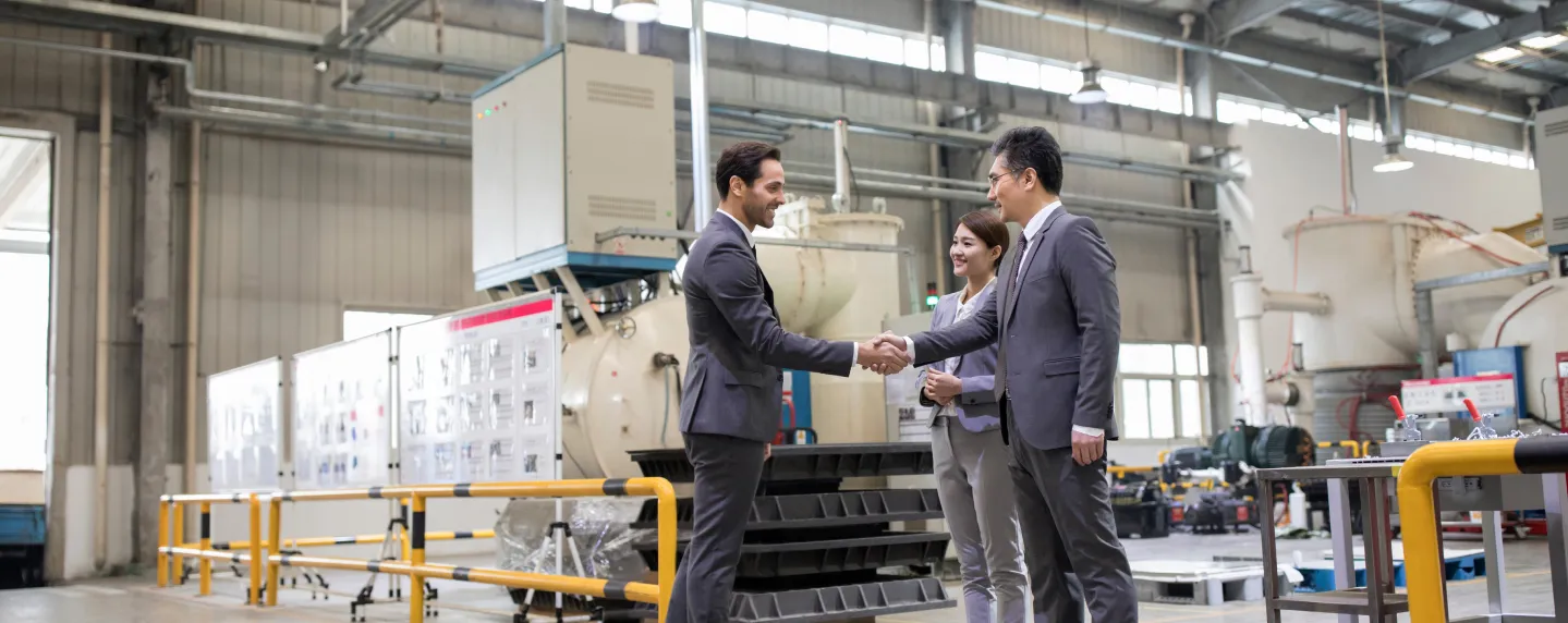 Business deal handshake in warehouse