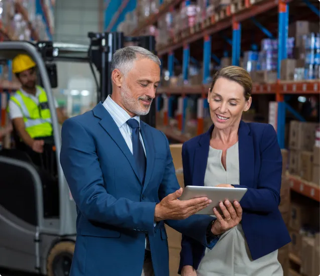 man and woman discussing project in warehouse