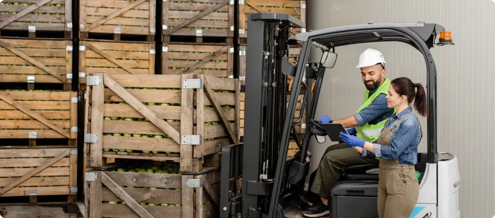 man transporting palettes in warehouse