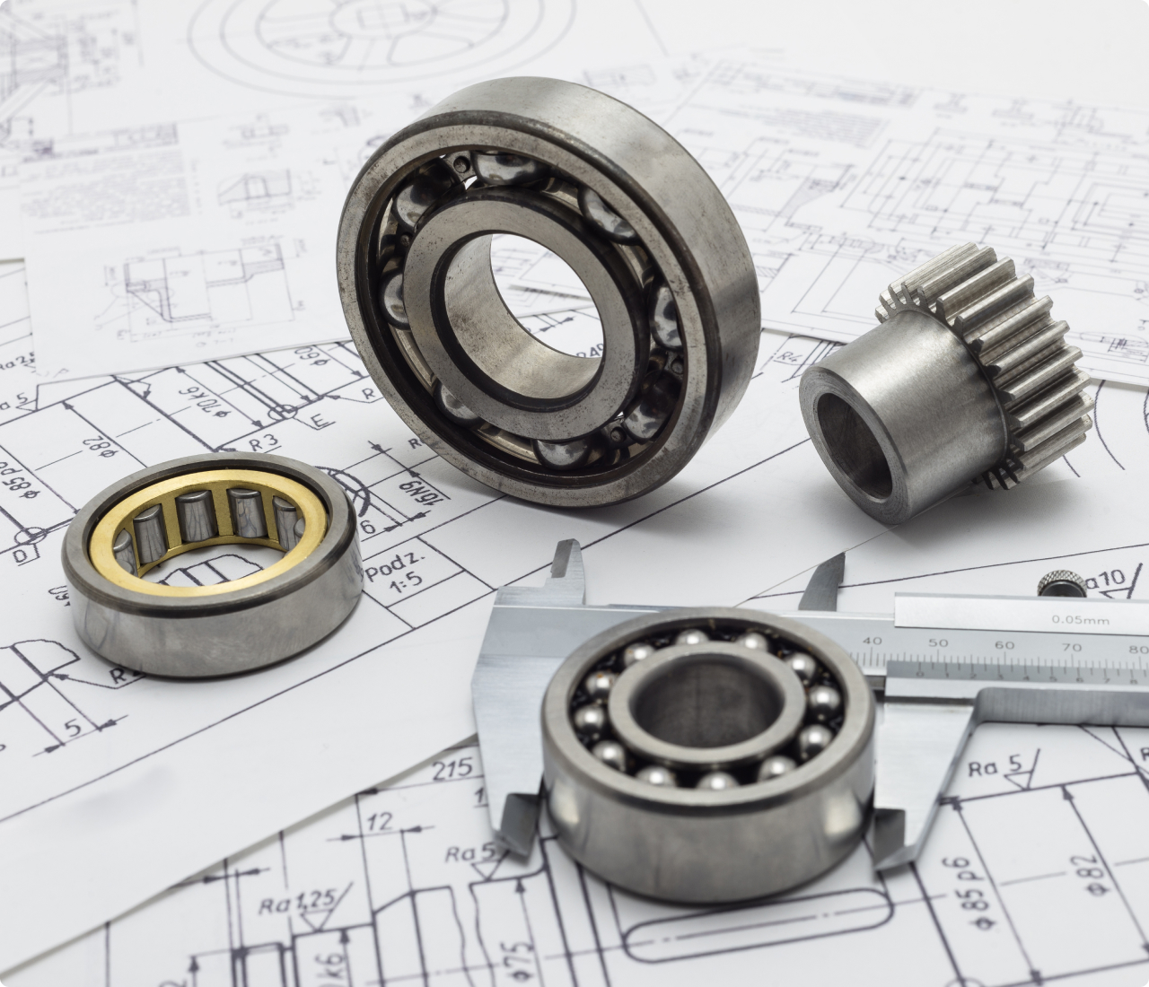 Engineering drawings and papers with components on them