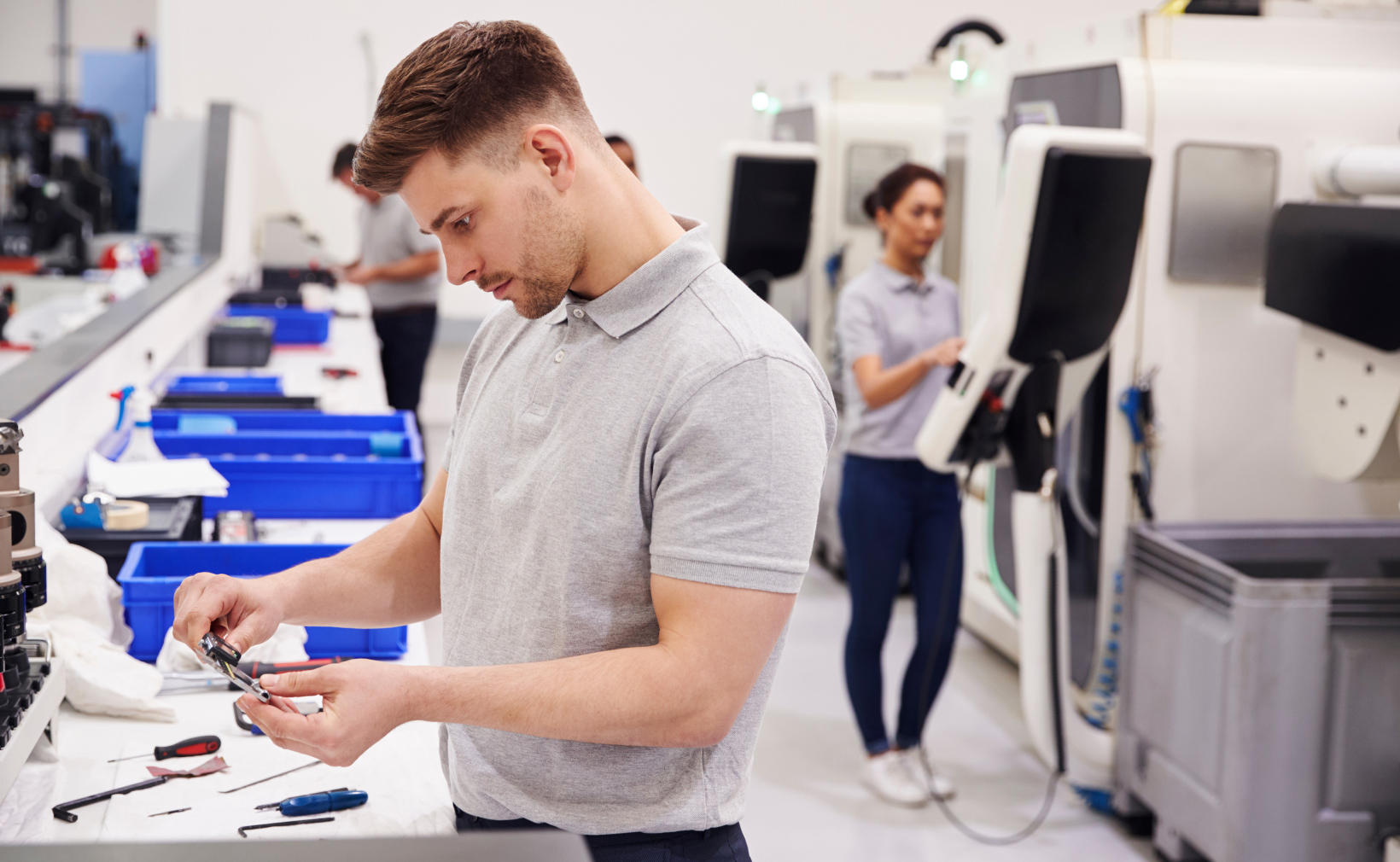 Young man testing component for quality assurance
