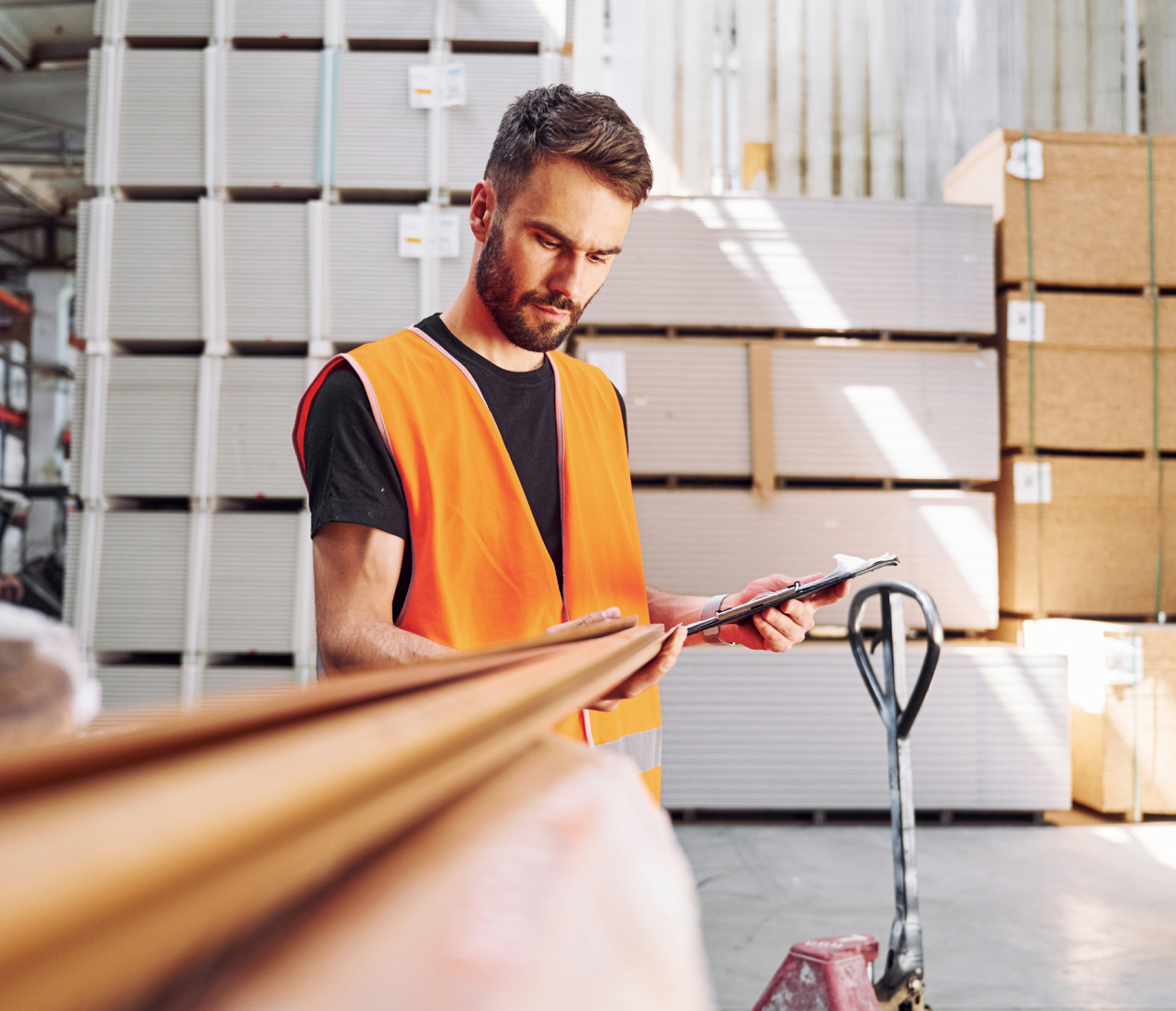 Young man with orange vest checking material