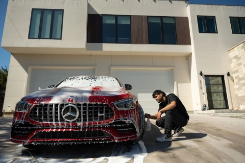 a boy washing the car