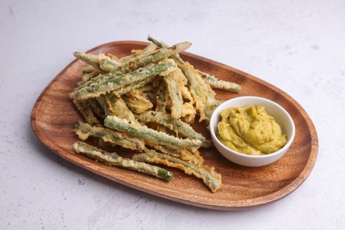 Tempura green beans on serving board