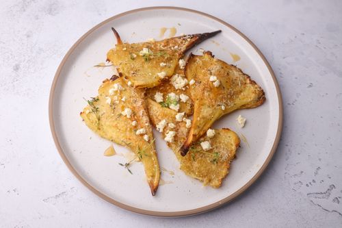Plate of crispy roasted parsnips ready to serve