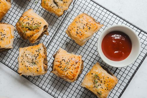 Vegetarian sausage rolls on cooling rack