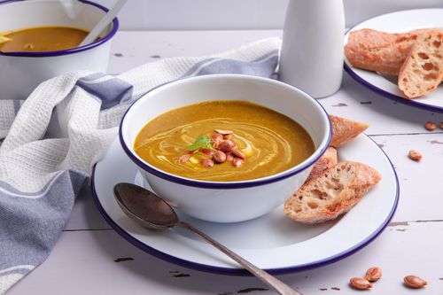Bowl of creamy pumpkin soup with toast