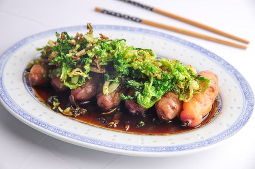 Braised yams on a serving dish with cabbage